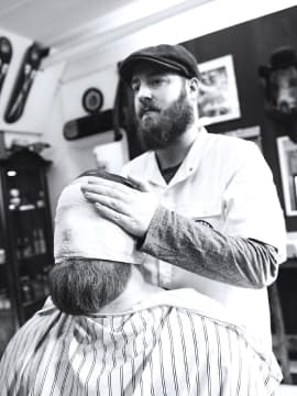 master shaves the client's beard
